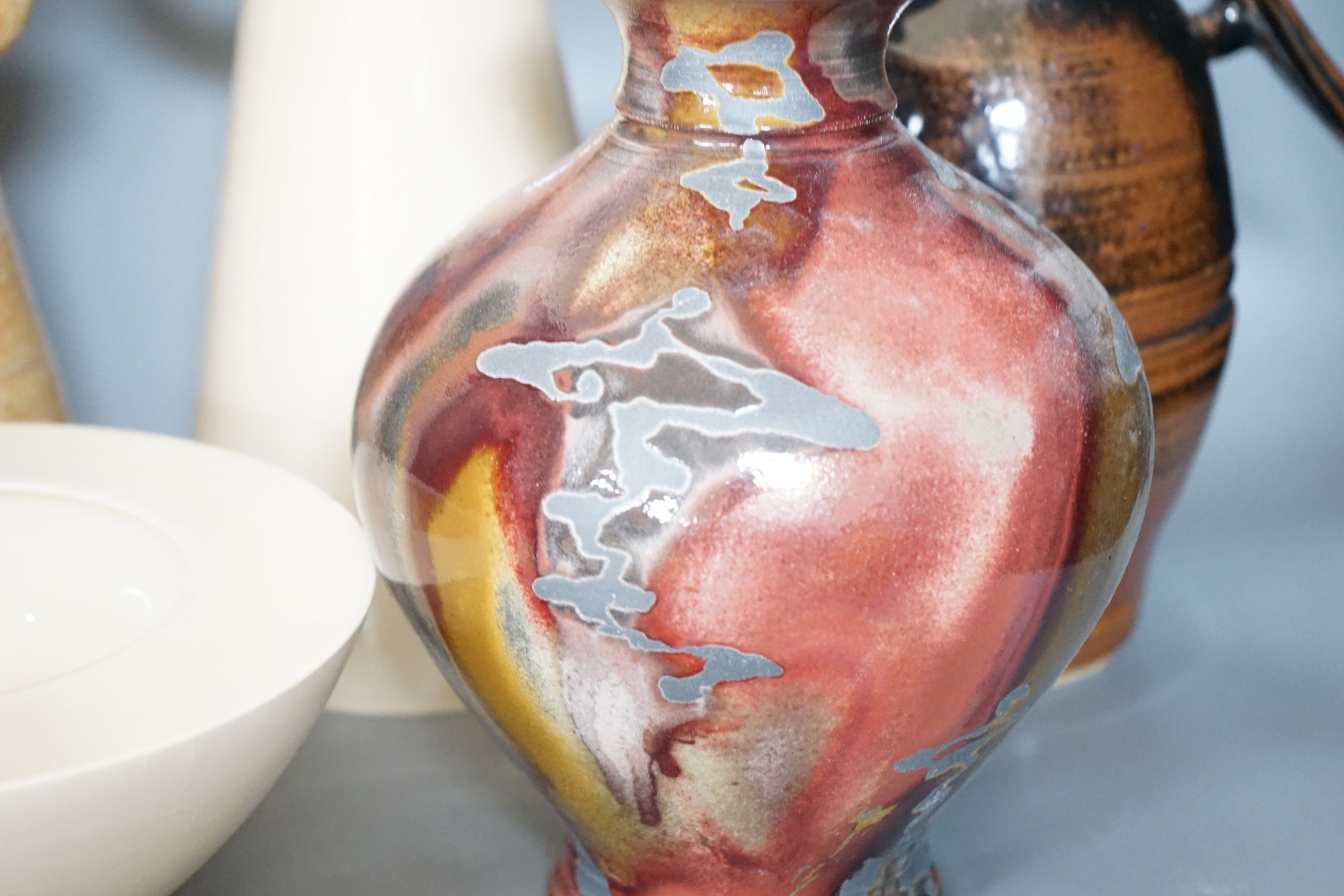 Studio pottery - a Duncan Beattie large stoneware jug, a Trevor Chaplin stoneware lidded jar, an Andrew Mason ruby and silver lustre vase and two Julian Bellmont cream glazed items – a jug and a similar bowl 33cm